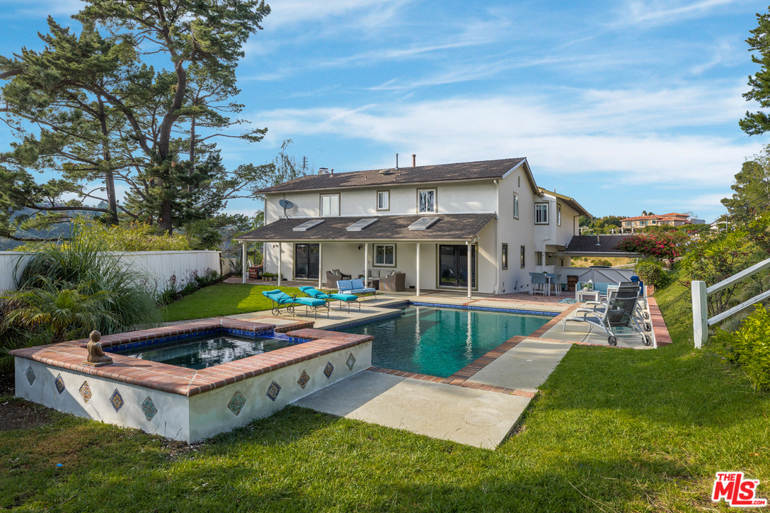 a front view of house with yard swimming pool and seating