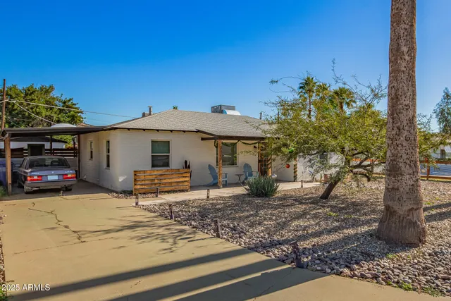 a view of a house with a yard and sitting area