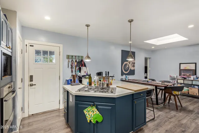 a view of dining table chairs and chandelier