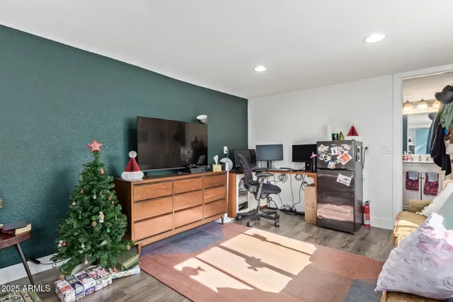 a living room with furniture and a flat screen tv