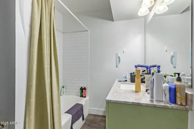 a bathroom with a granite countertop sink and a mirror