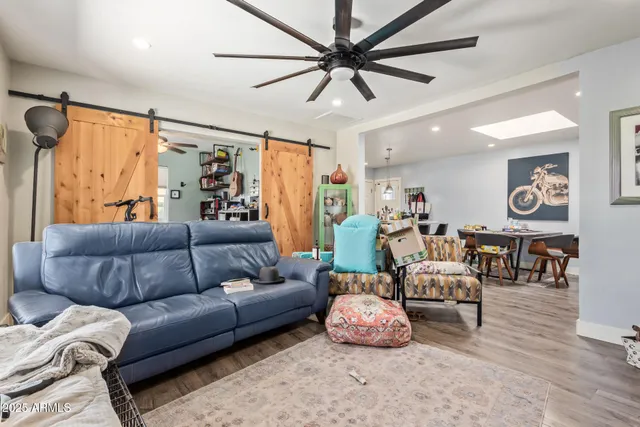 a living room with furniture and wooden floor