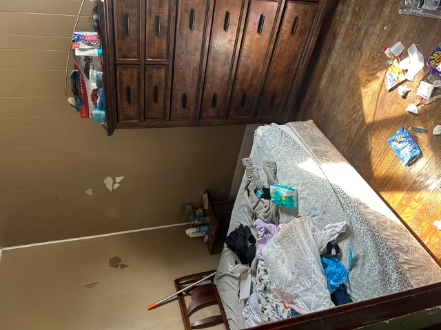 view of a room with rack and wooden floor