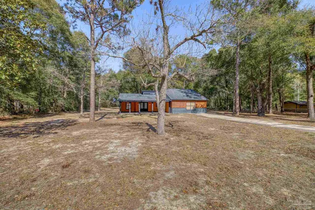 a view of a house with a backyard