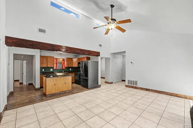 a kitchen with stainless steel appliances granite countertop a refrigerator and a sink