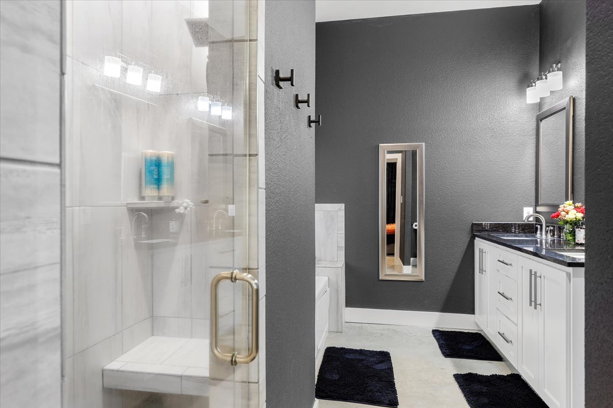 145 Cardinal Loop Paige, TX 78659 - Photo 25 of 40 A well-appointed bathroom features a spacious walk-in shower and a sleek vanity.