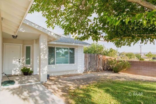 432 Ashton Street Ridgecrest, CA 93555 - Photo 4 of 31 a view of a house with backyard and a tree