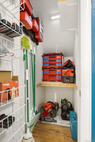 a utility room with lots of clutter and cabinets