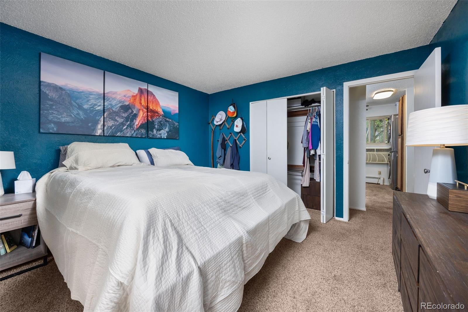 3771 Quail Street Wheat Ridge, CO 80033 - Photo 14 of 25 a bed sitting in a bedroom and a flat tv screen tv