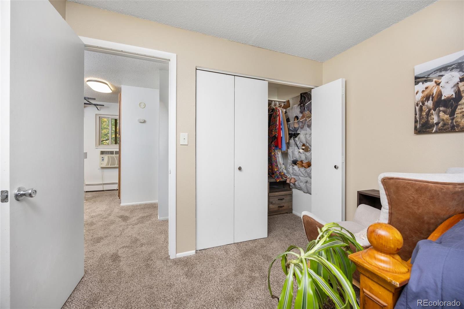 3771 Quail Street Wheat Ridge, CO 80033 - Photo 16 of 25 a view of a livingroom with furniture and a hallway
