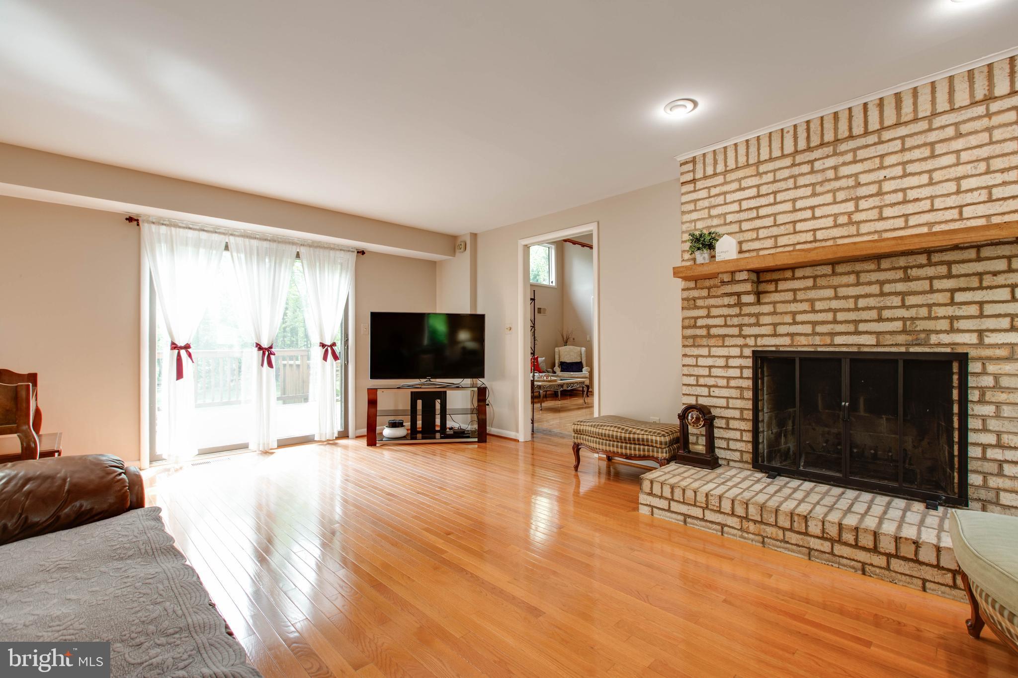 5519 Woodbine Road Sykesville, MD 21784 - Photo 22 of 69 a living room with furniture flat screen tv and a fireplace