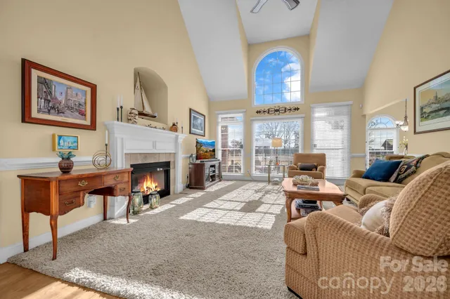 a living room with furniture a fireplace and a table
