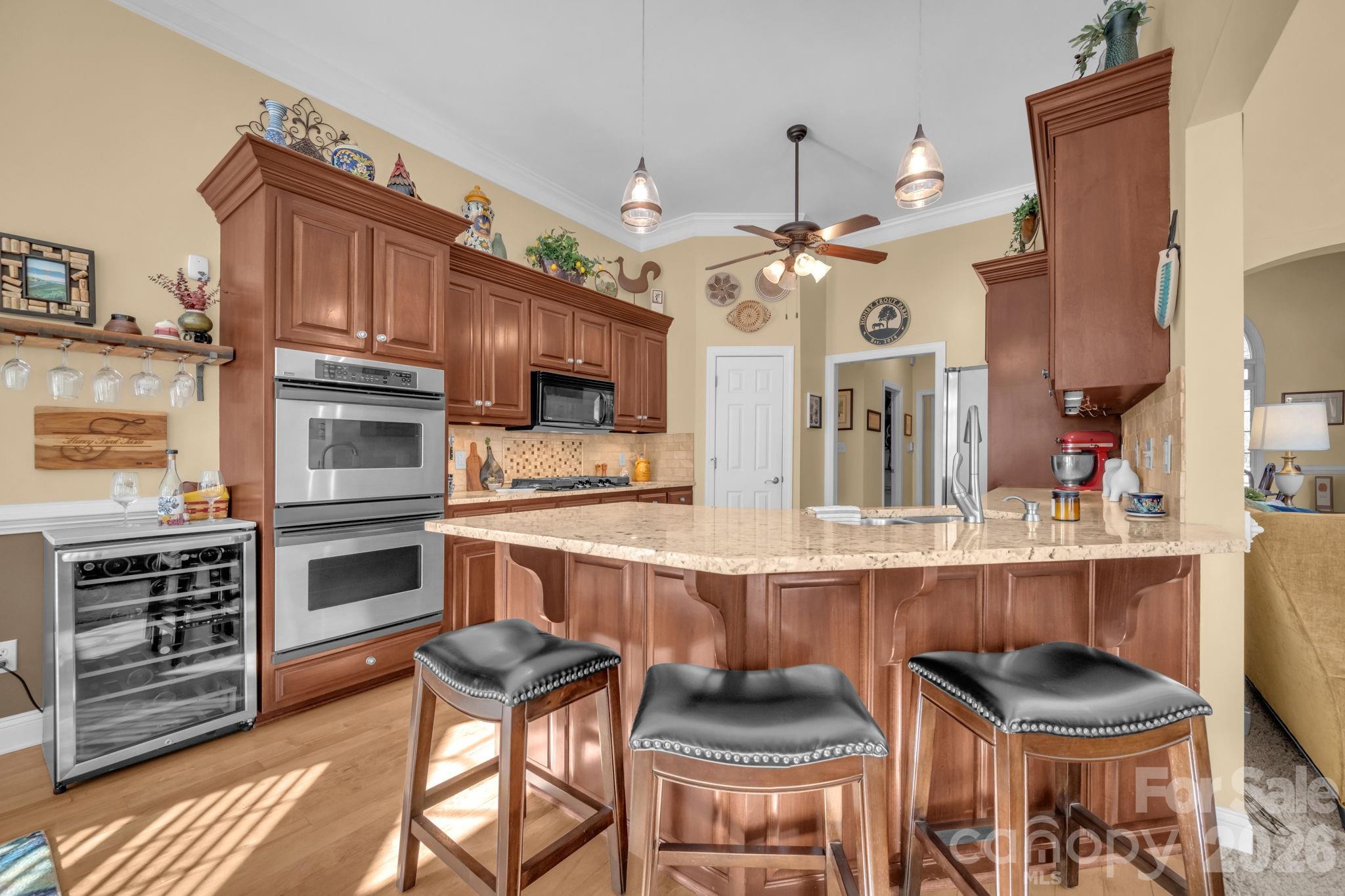 5432 Highway 218 Monroe, NC 28110 - Photo 14 of 48 a kitchen with stainless steel appliances kitchen island granite countertop a stove a sink and a refrigerator