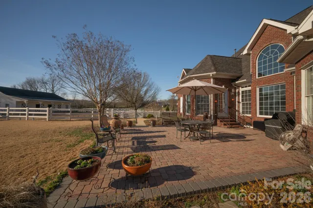 a view of a house with backyard patio and swimming pool