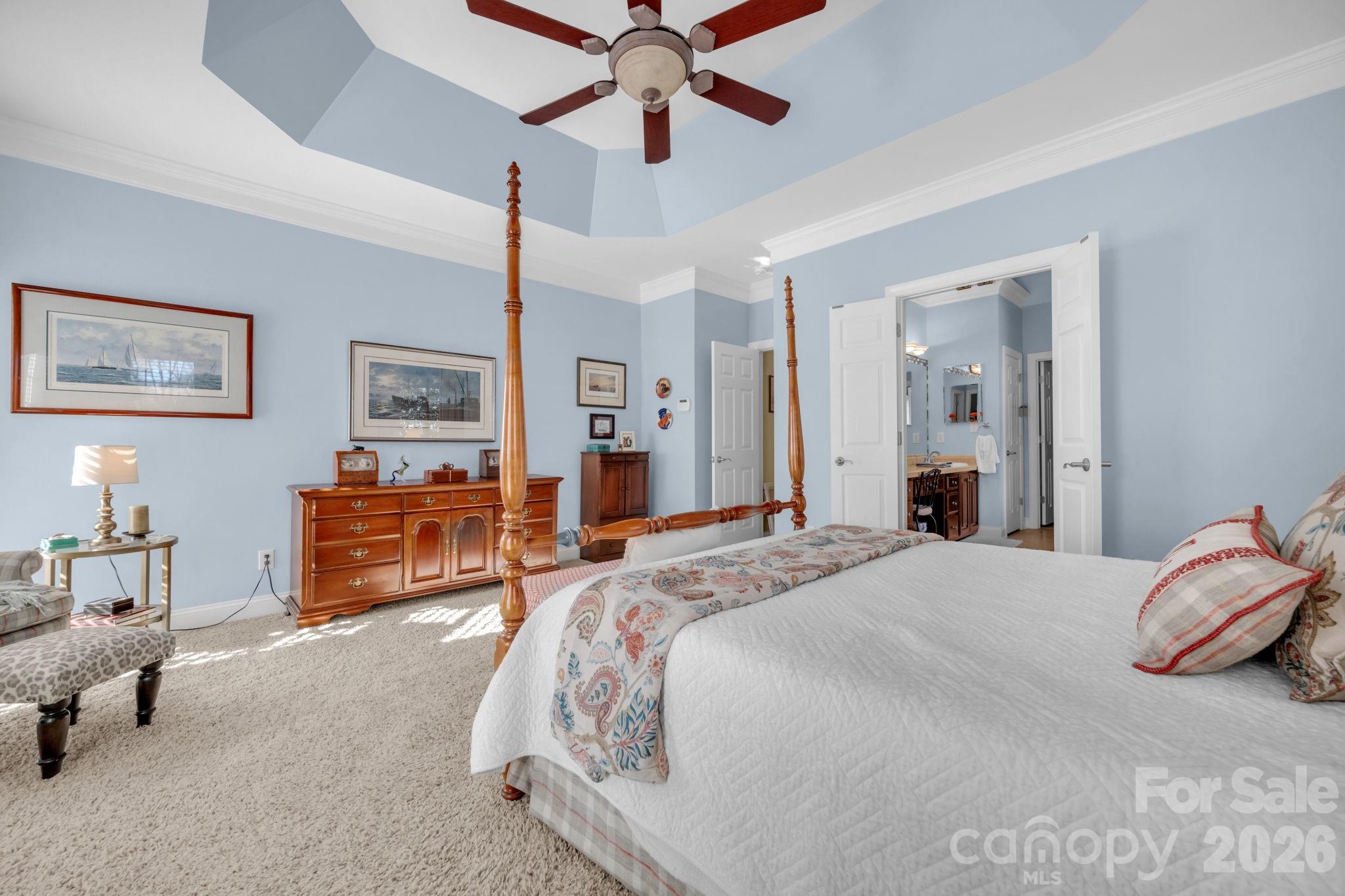 5432 Highway 218 Monroe, NC 28110 - Photo 19 of 48 a spacious bedroom with a bed a dresser and a chandelier