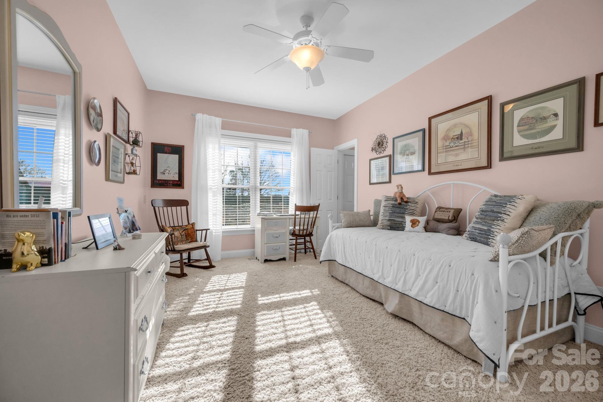 5432 Highway 218 Monroe, NC 28110 - Photo 22 of 48 a spacious bedroom with a bed a couch and a chandelier