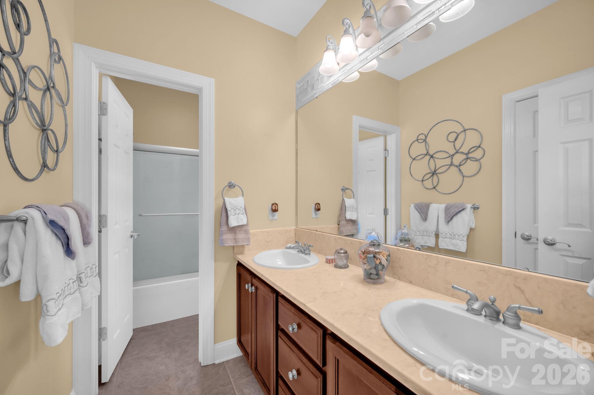 5432 Highway 218 Monroe, NC 28110 - Photo 24 of 48 a bathroom with a double vanity sink mirror and shower