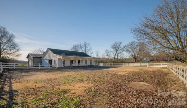 a front view of residential houses with yard and trees