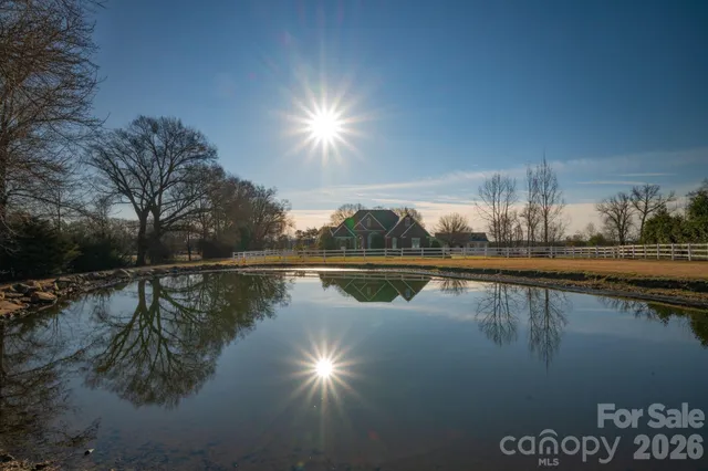 a view of dirt road with a building in the background