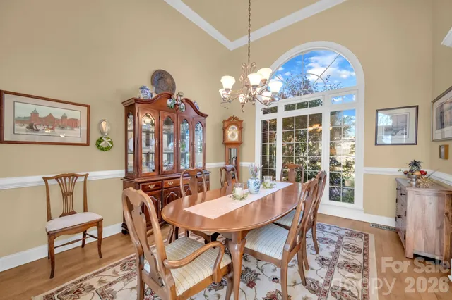 a view of a dining room with furniture chandelier and wooden floor