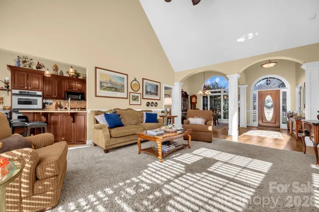 a living room with furniture kitchen view and a rug