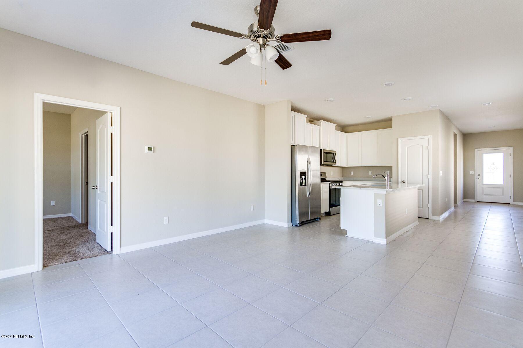 235 Brybar Drive St. Augustine, FL 32095 - Photo 3 of 11 a view of a kitchen with a sink and a refrigerator