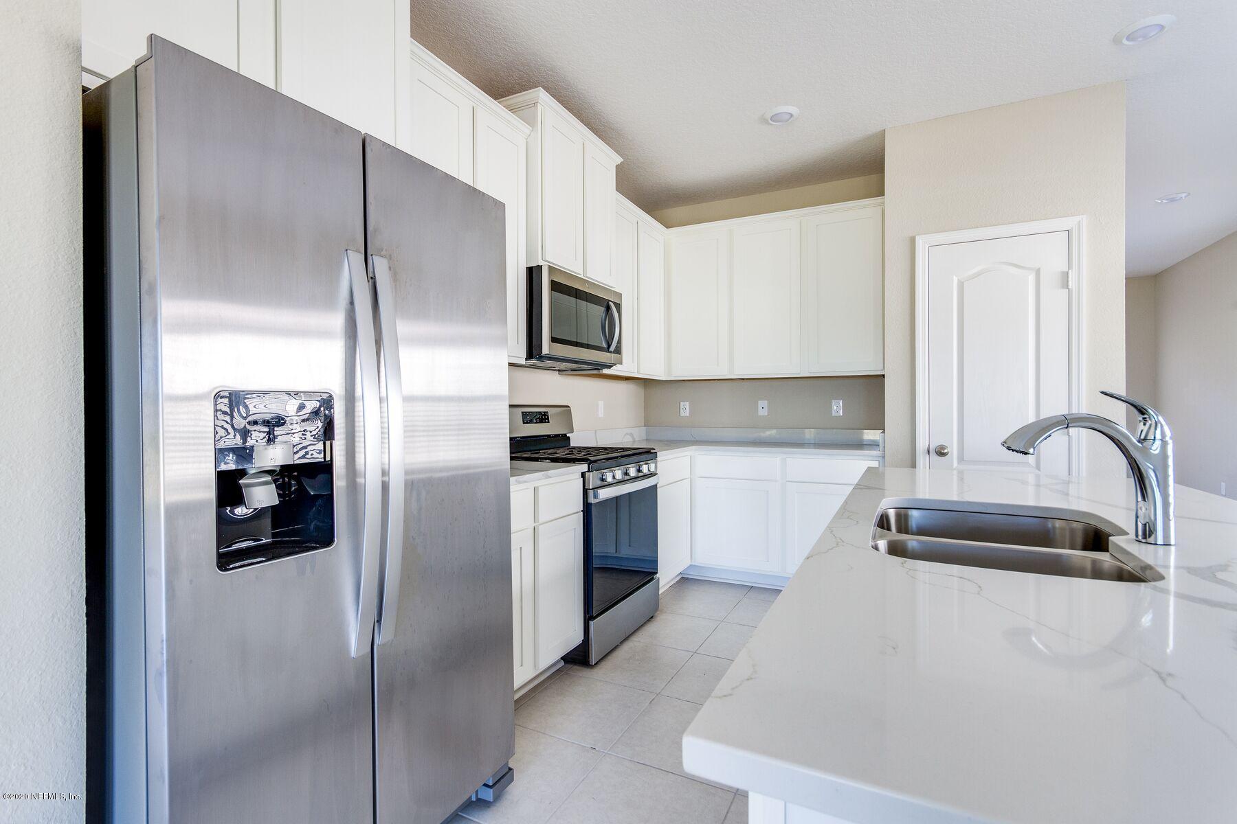 235 Brybar Drive St. Augustine, FL 32095 - Photo 5 of 11 a kitchen with stainless steel appliances granite countertop a refrigerator and a sink