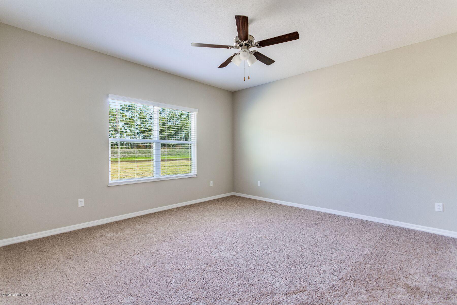 235 Brybar Drive St. Augustine, FL 32095 - Photo 8 of 11 an empty room with a window and a ceiling fan