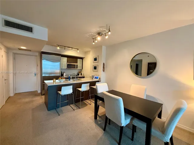a living room with furniture coffee table and a large window