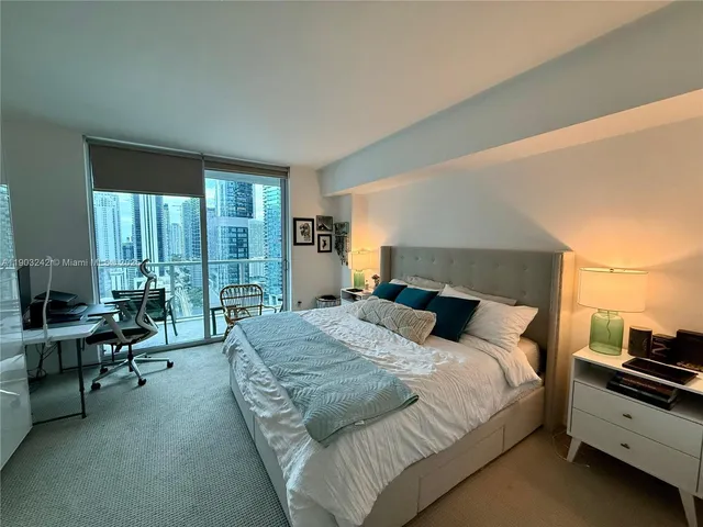 a large bedroom with a large bed and a couch