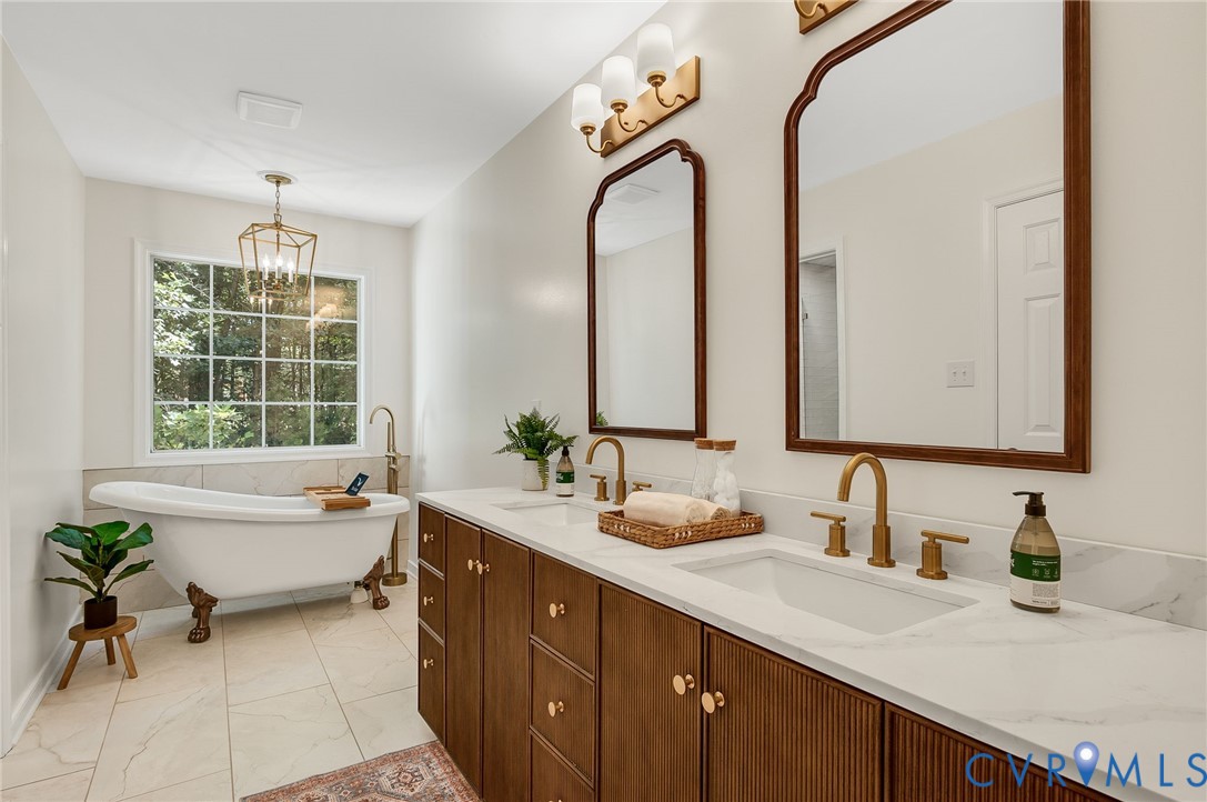 2620 Academy Road Powhatan, VA 23139 - Photo 14 of 49 a spacious bathroom with a double vanity sink mirror and a bathtub