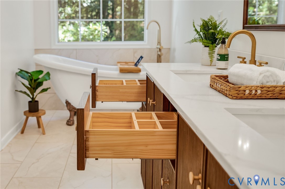 2620 Academy Road Powhatan, VA 23139 - Photo 16 of 49 a bathroom with a sink a potted plant and a window