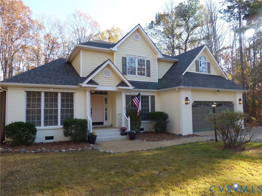 2620 Academy Road Powhatan, VA 23139 - Photo 2 of 49 a front view of a house with a yard and garage