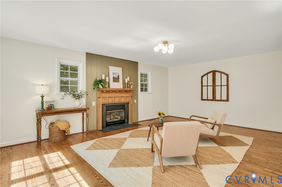 2620 Academy Road Powhatan, VA 23139 - Photo 29 of 49 a living room with furniture a fireplace and a floor to ceiling window