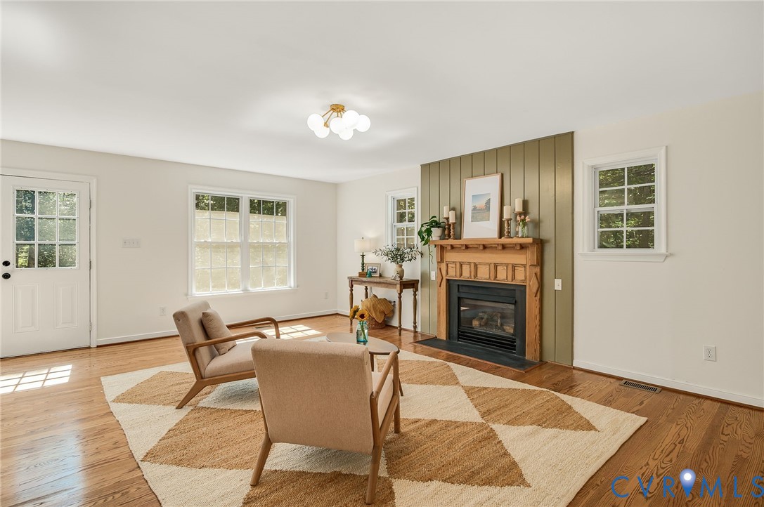2620 Academy Road Powhatan, VA 23139 - Photo 30 of 49 a living room with furniture a fireplace and next to windows