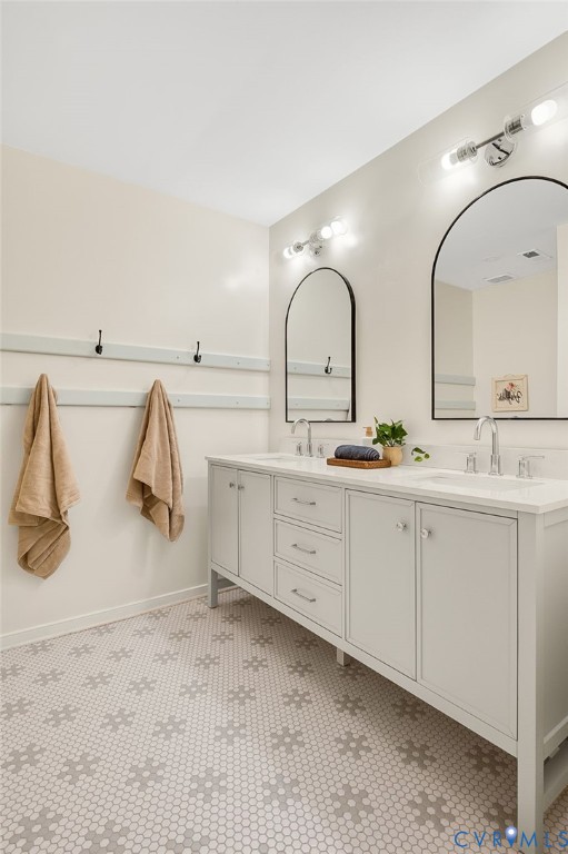 2620 Academy Road Powhatan, VA 23139 - Photo 35 of 49 a bathroom with a double vanity sink and mirror