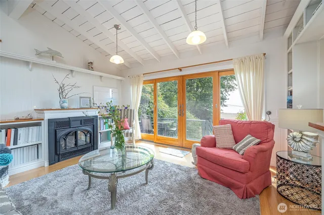 a living room with furniture a fireplace and a large window