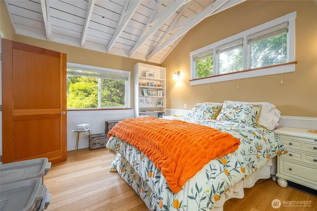 a bed sitting in a bedroom next to a window