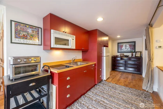 a kitchen with granite countertop cabinets stainless steel appliances and a window