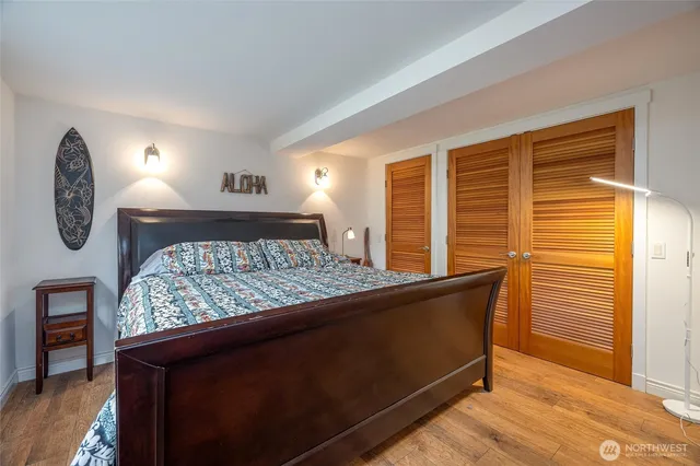 a bed sitting in a bedroom next to a window