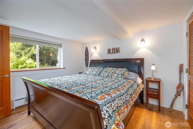 a bed sitting in a bedroom next to a window