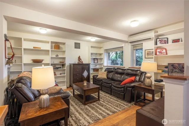 a living room with furniture fireplace and a window