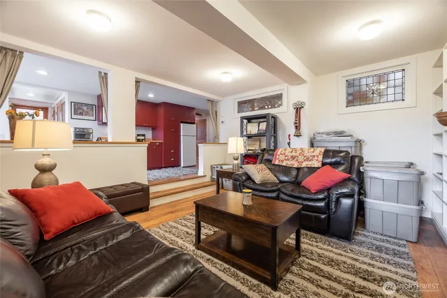 a living room with furniture and a wooden floor