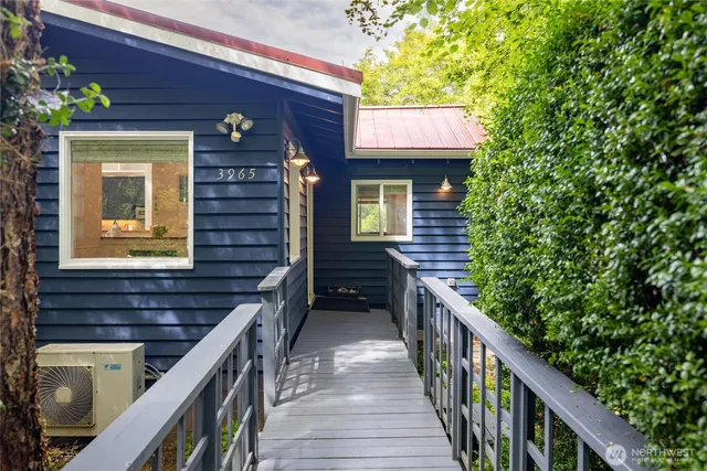 a view of a house with wooden stairs and deck