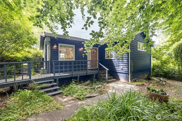 a view of a house with a small yard and wooden fence
