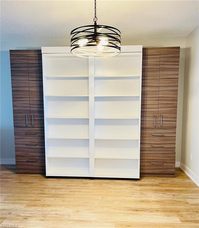5499 Rattlesnake Hamm Road, Unit A207 Naples, FL 34113 - Photo 24 of 32 a view of walk in closet with empty racks