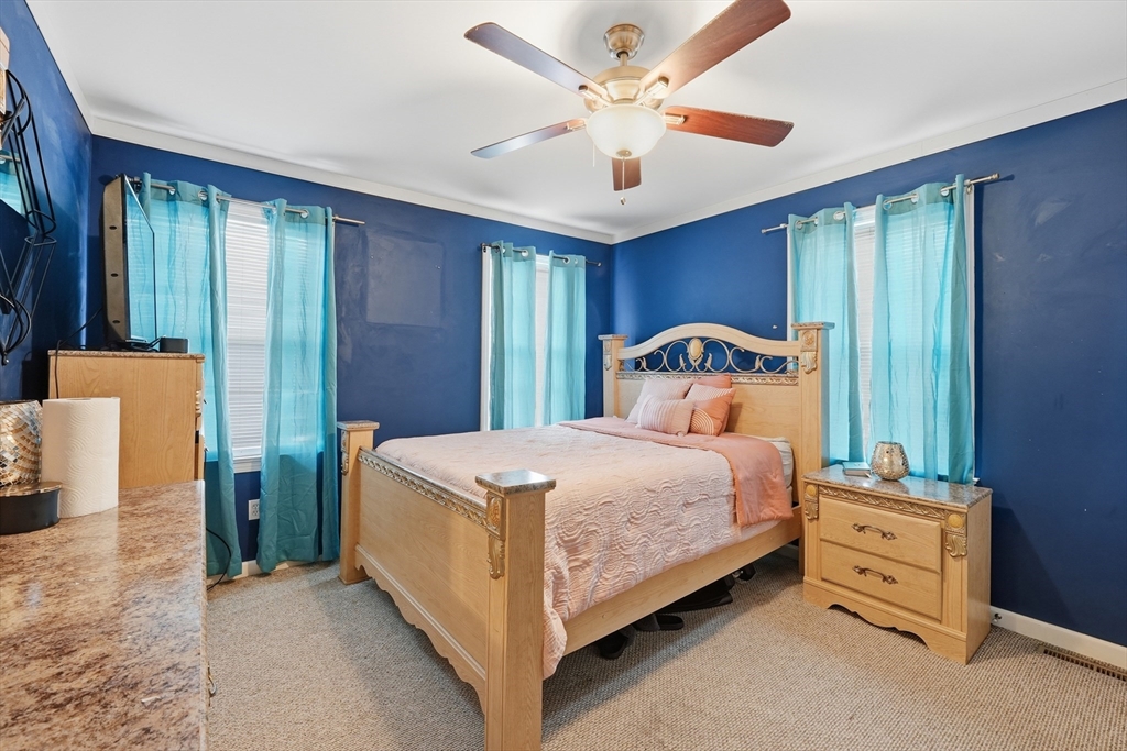 19 Annies Way Springfield, MA 01119 - Photo 22 of 40 a bedroom with a bed and a chandelier
