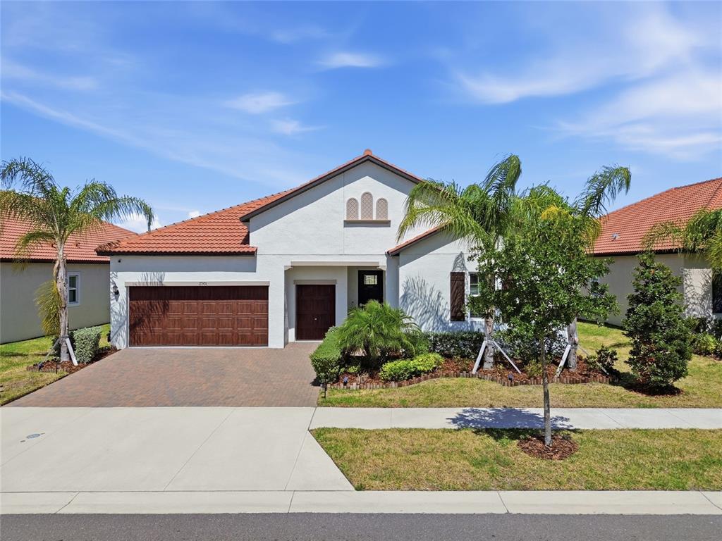 17301 Scuba Crest Street Wimauma, FL 33598 - Photo 1 of 37 a front view of a house with a yard