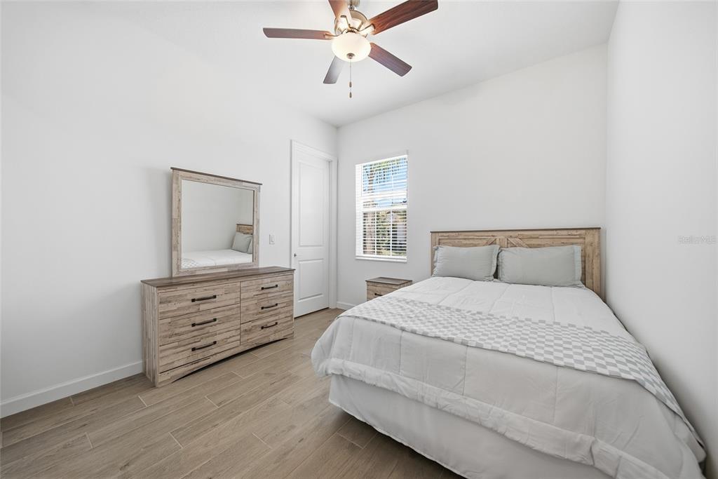 17301 Scuba Crest Street Wimauma, FL 33598 - Photo 14 of 37 a bedroom with a bed and a dresser