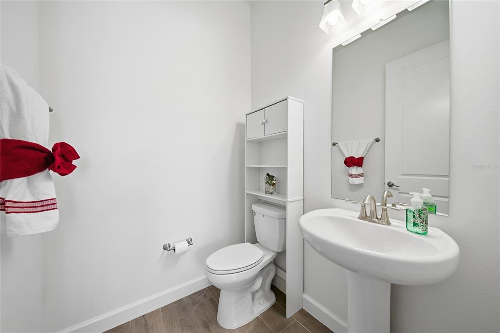 17301 Scuba Crest Street Wimauma, FL 33598 - Photo 18 of 37 a bathroom with a sink toilet and shower